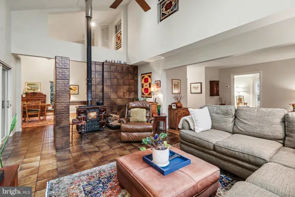 a living room with furniture kitchen view and a rug