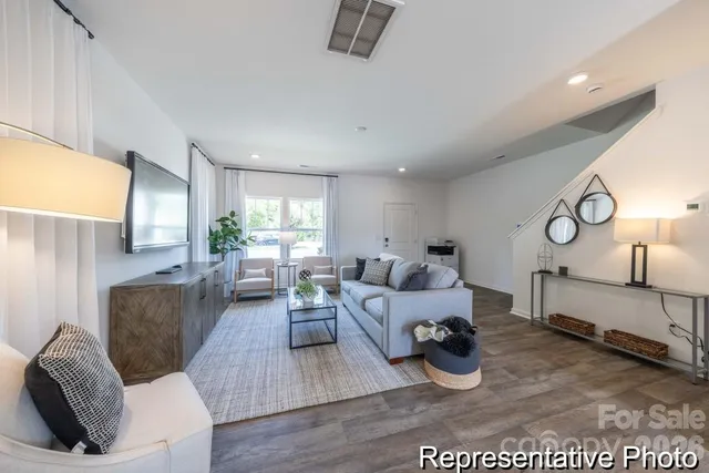 a living room with furniture window and wooden floor