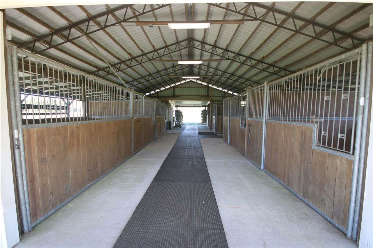 5559 Allie Rae Street Milton, FL 32570 - Photo 46 of 50 of the barn. Galvanized horse stalls.