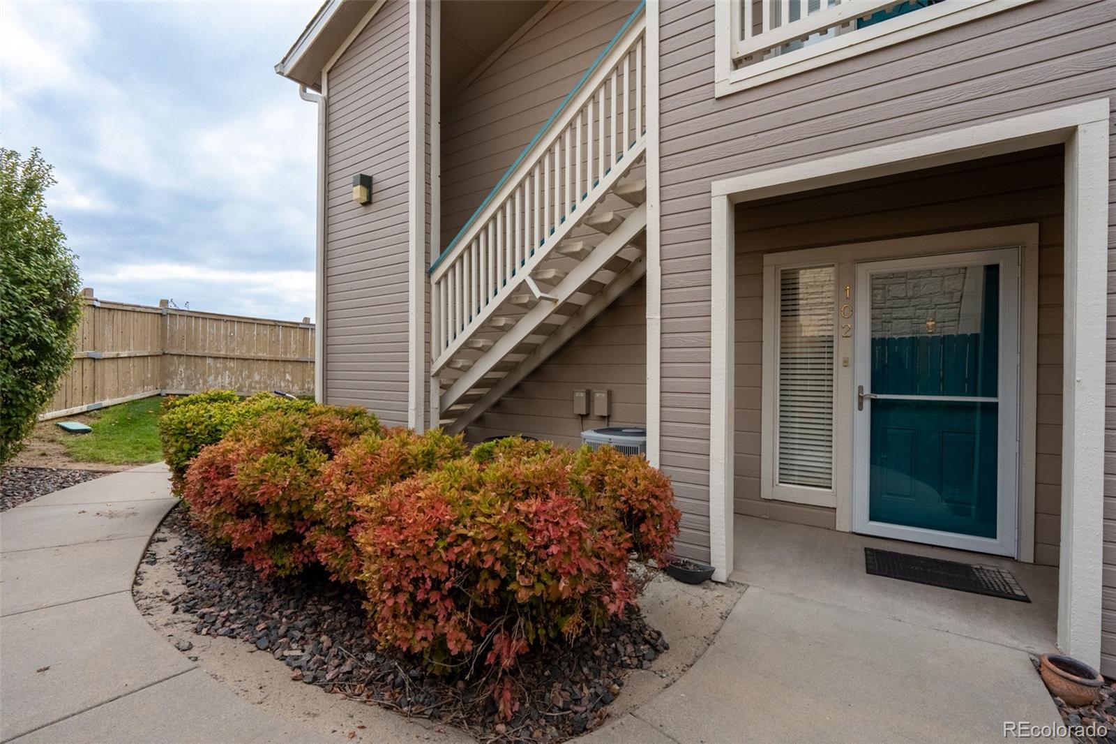 a view of a house with a garage and balcony