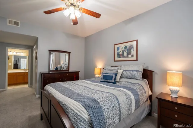 a bedroom with bed and a chandelier