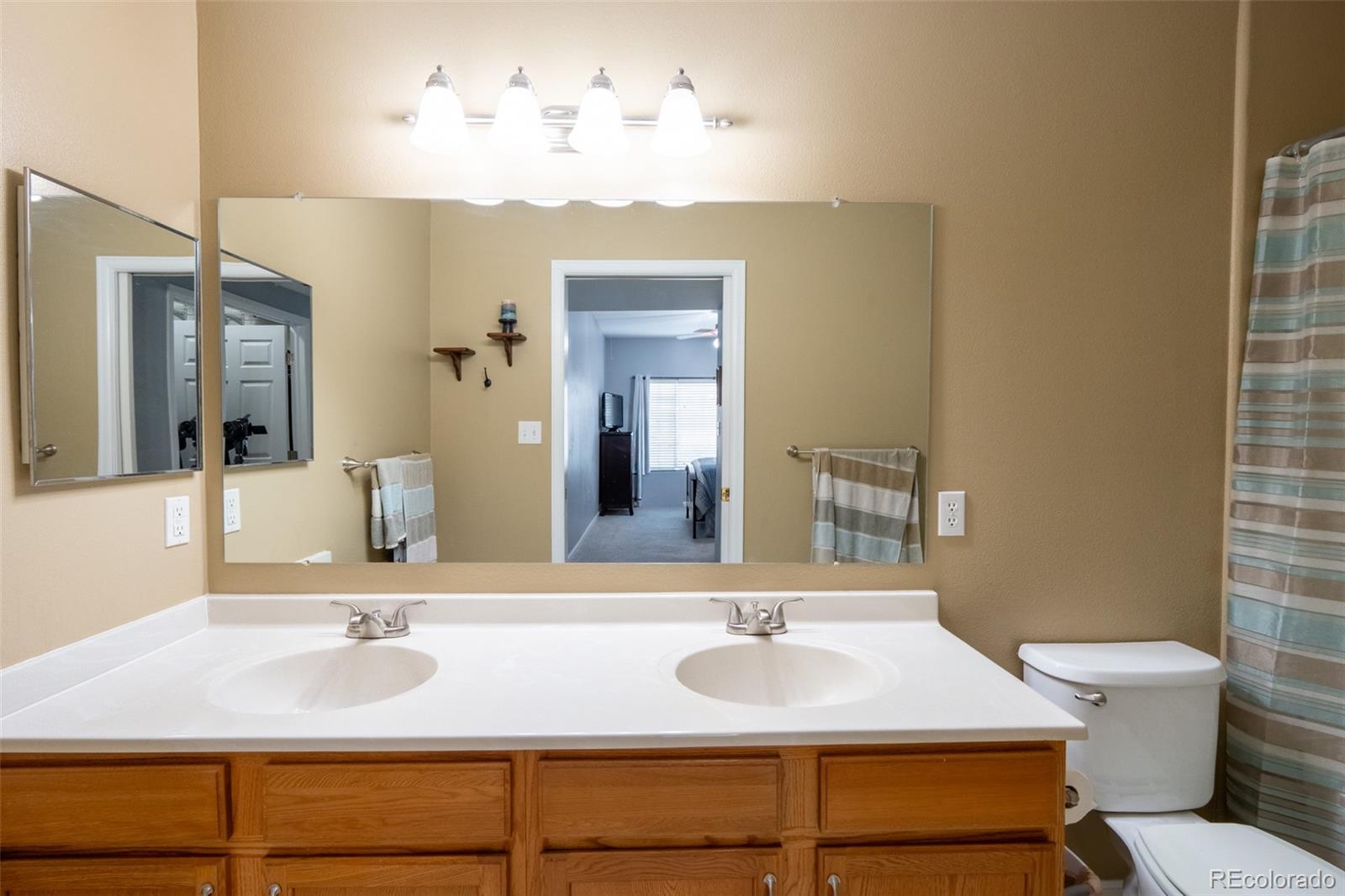 8495 Pebble Creek Way, Unit 102 Highlands Ranch, CO 80126 - Photo 13 of 22 a bathroom with a sink and a mirror
