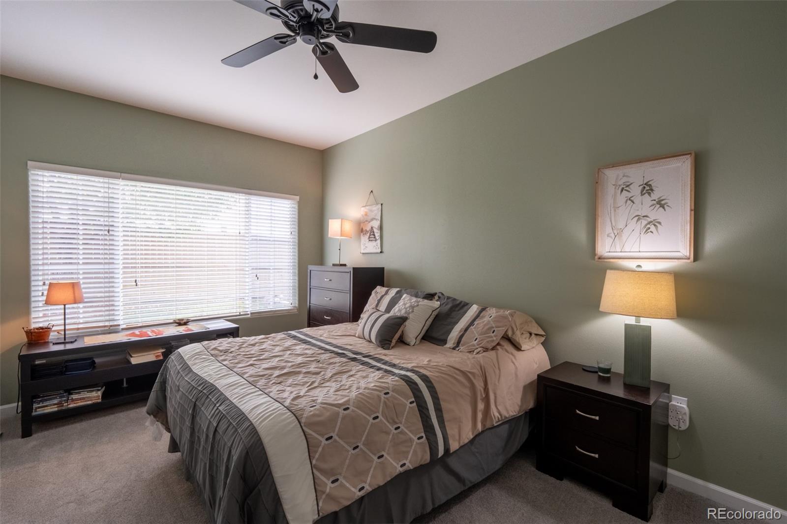 8495 Pebble Creek Way, Unit 102 Highlands Ranch, CO 80126 - Photo 15 of 22 a bedroom with a bed and a window