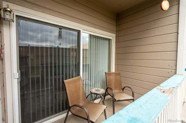 a view of a chair and tables in the balcony