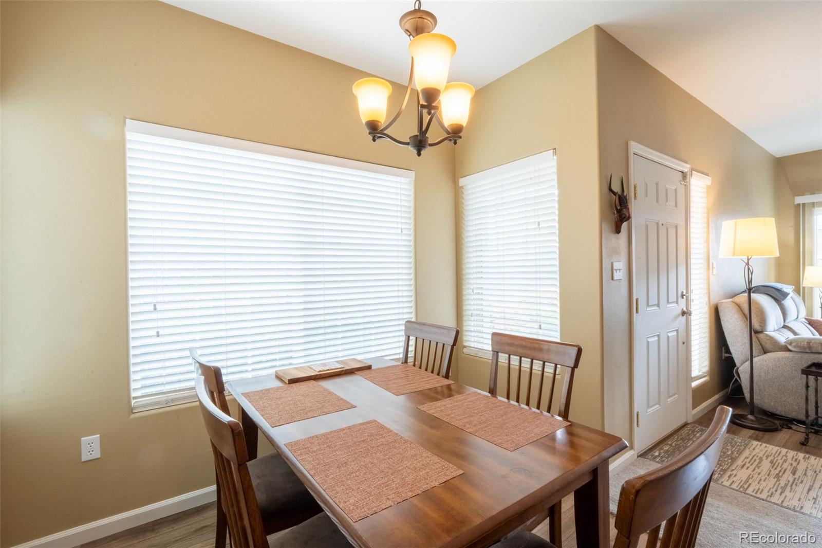 8495 Pebble Creek Way, Unit 102 Highlands Ranch, CO 80126 - Photo 6 of 22 a view of a dining room with furniture window and wooden floor
