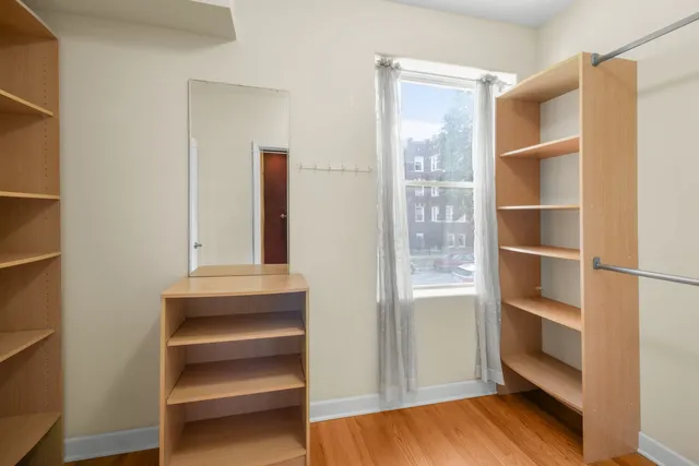 a view of walk in closet with empty racks