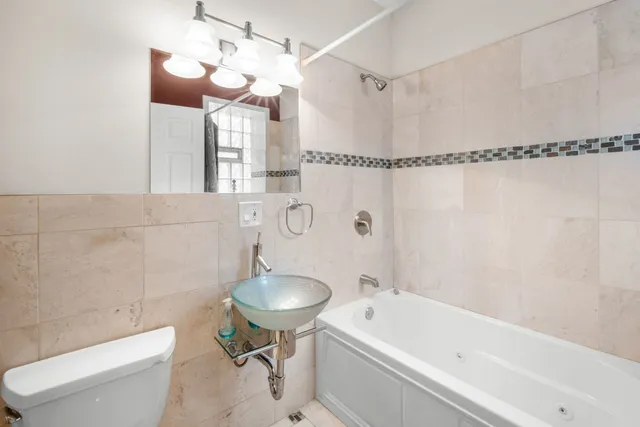 a bathroom with a sink a toilet and bathtub