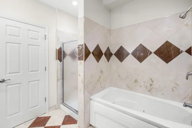 a bathroom with a bathtub and shower