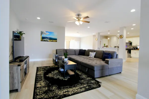 a living room with furniture and a chandelier