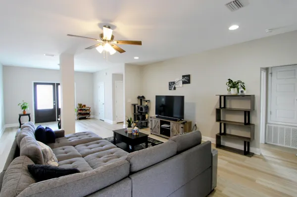 a living room with furniture and a flat screen tv