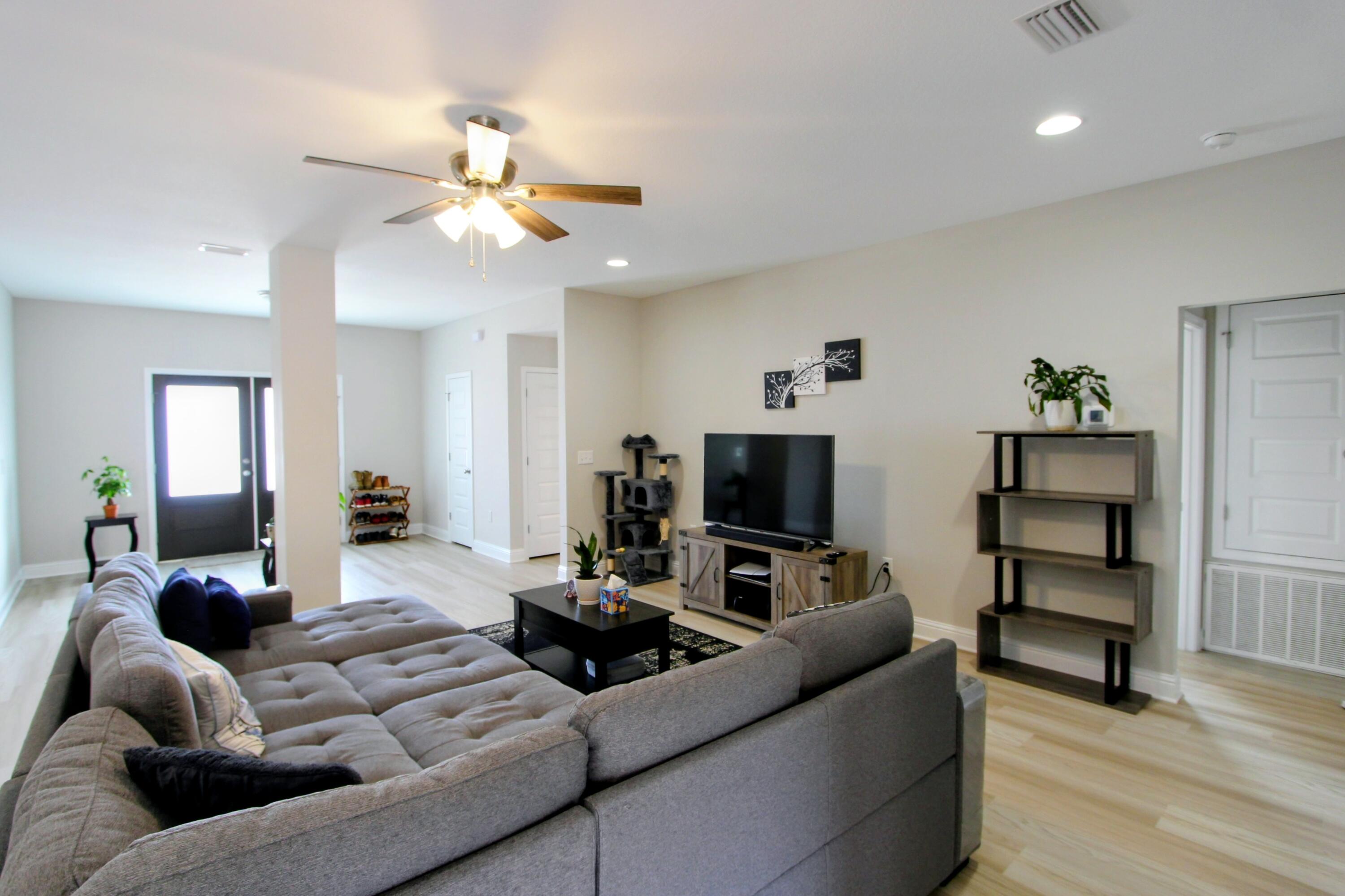 5438 Lee Farm Boulevard Crestview, FL 32536 - Photo 15 of 50 a living room with furniture and a flat screen tv