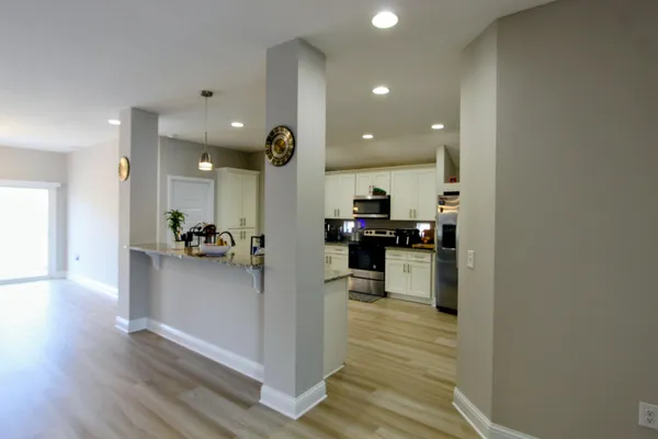 a view of living room with furniture and wooden floor