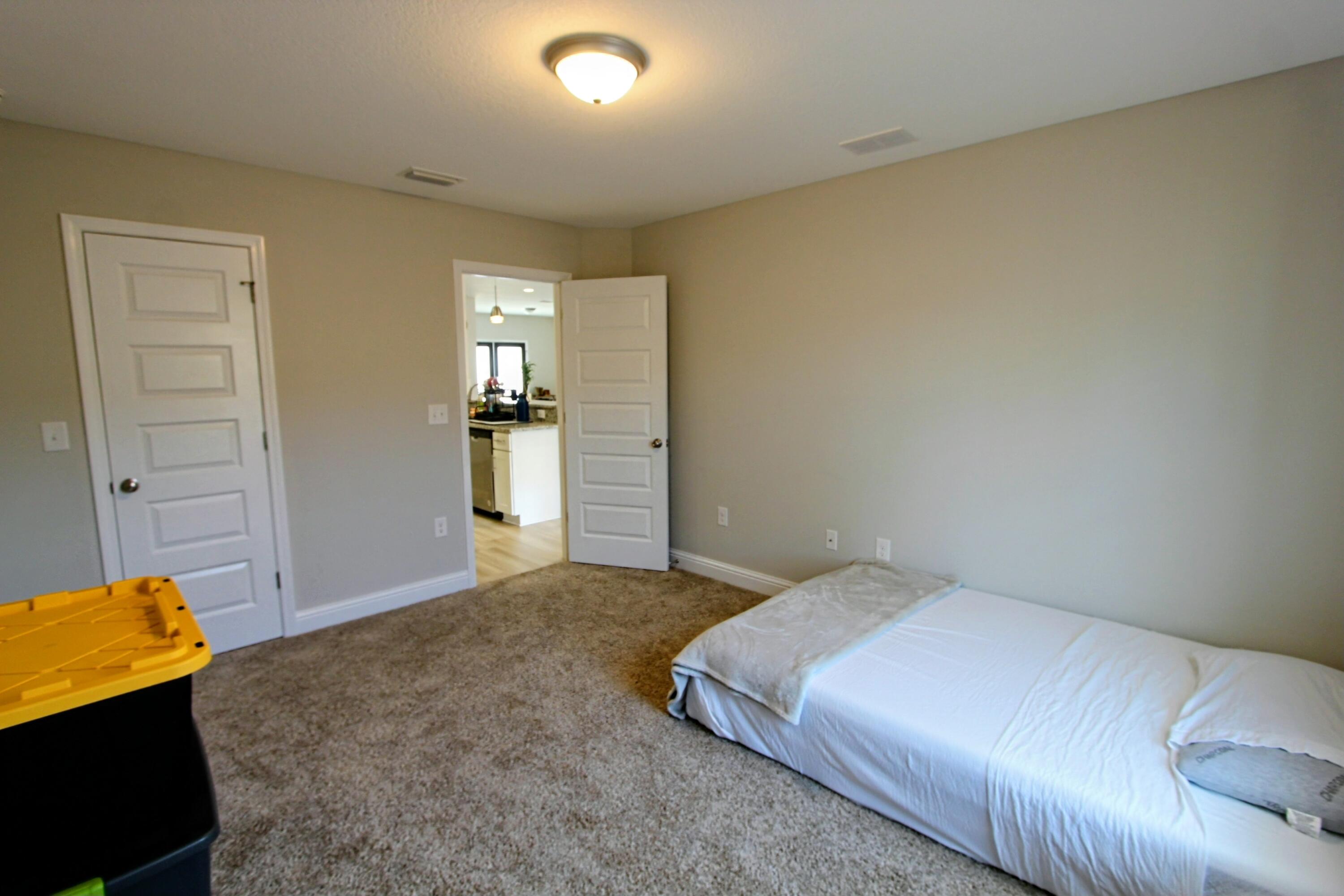 5438 Lee Farm Boulevard Crestview, FL 32536 - Photo 25 of 50 a bedroom with a bed and a walk in closet
