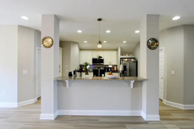 a view of living room with furniture and kitchen view