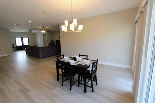 a view of a dining room with furniture wooden floor and chandelier