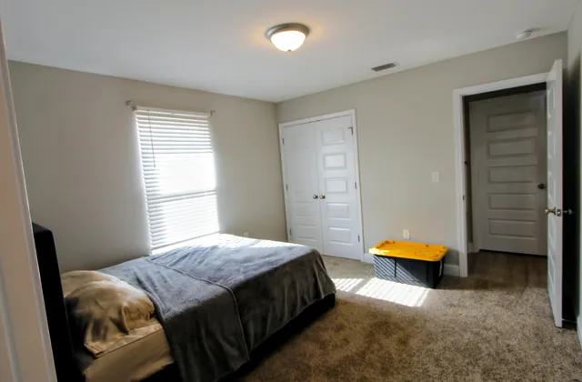 a bedroom with a bed and a window