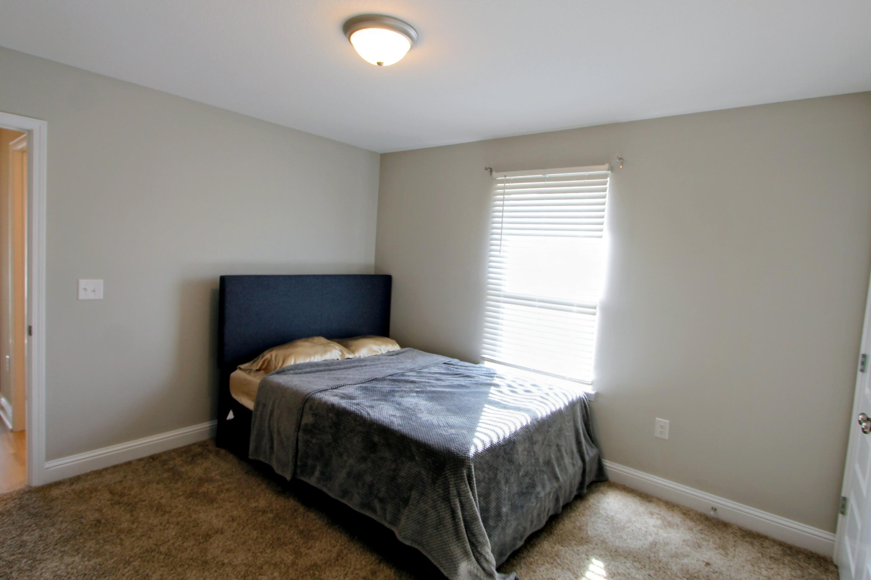 5438 Lee Farm Boulevard Crestview, FL 32536 - Photo 35 of 50 a bedroom with a bed and a window