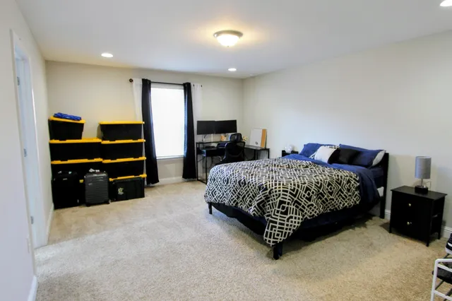 a bedroom with a bed and a flat screen television