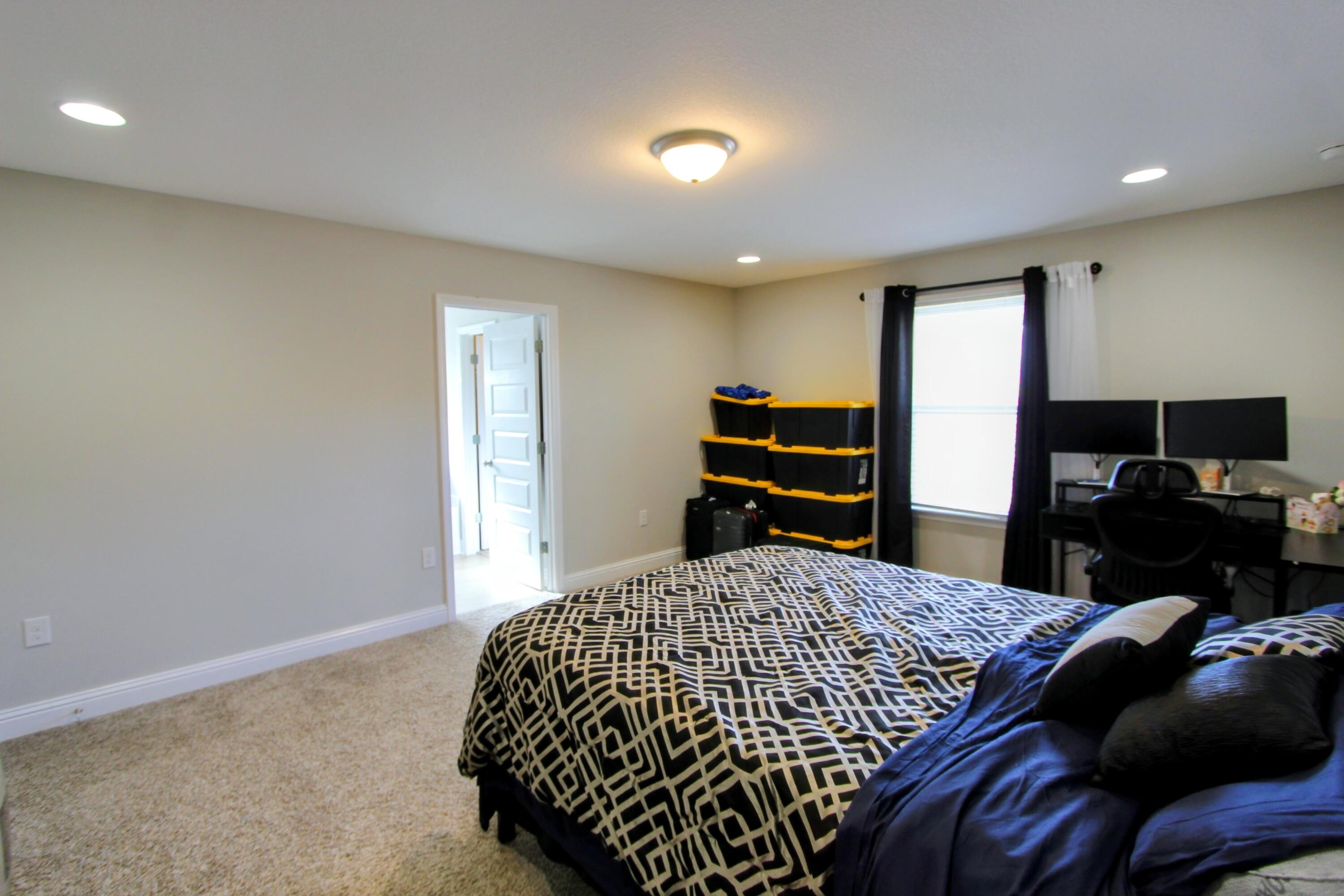 5438 Lee Farm Boulevard Crestview, FL 32536 - Photo 38 of 50 a bedroom with a bed and dresser with mirror