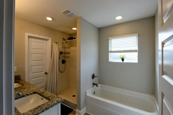 a bathroom with a granite countertop sink a toilet and shower