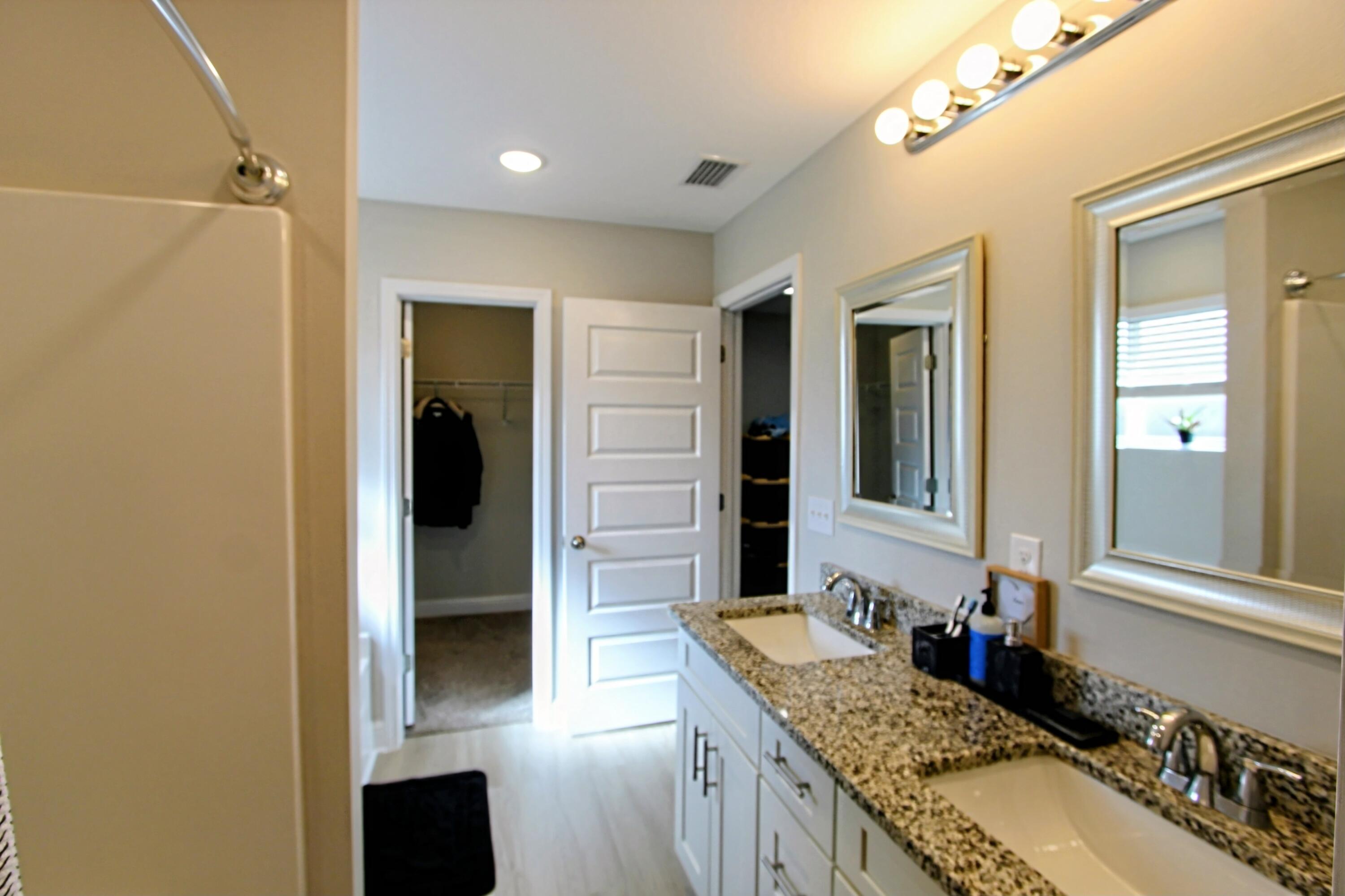 5438 Lee Farm Boulevard Crestview, FL 32536 - Photo 41 of 50 a bathroom with a granite countertop sink and a mirror