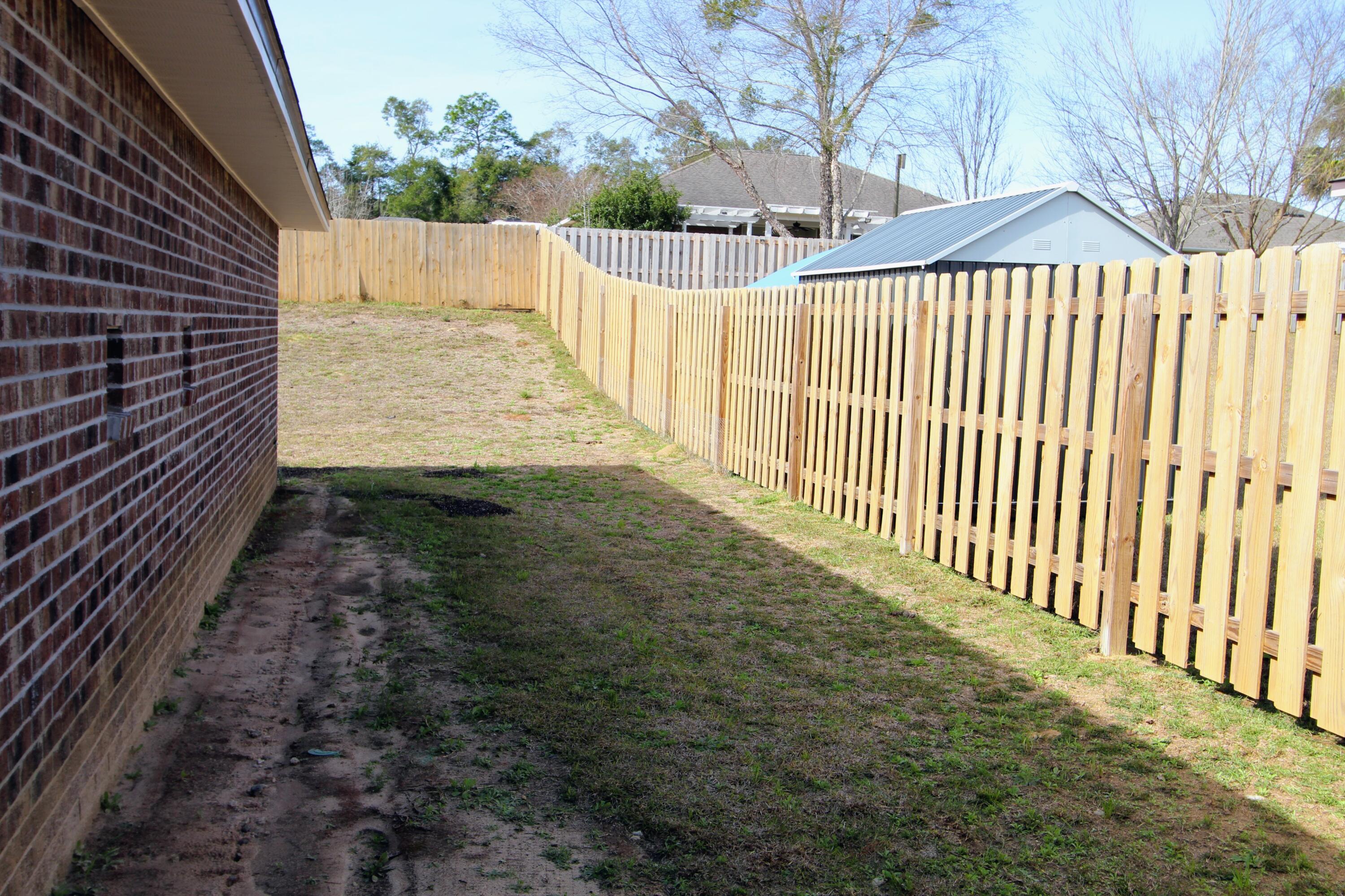 5438 Lee Farm Boulevard Crestview, FL 32536 - Photo 46 of 50 a view of a yard with wooden fence