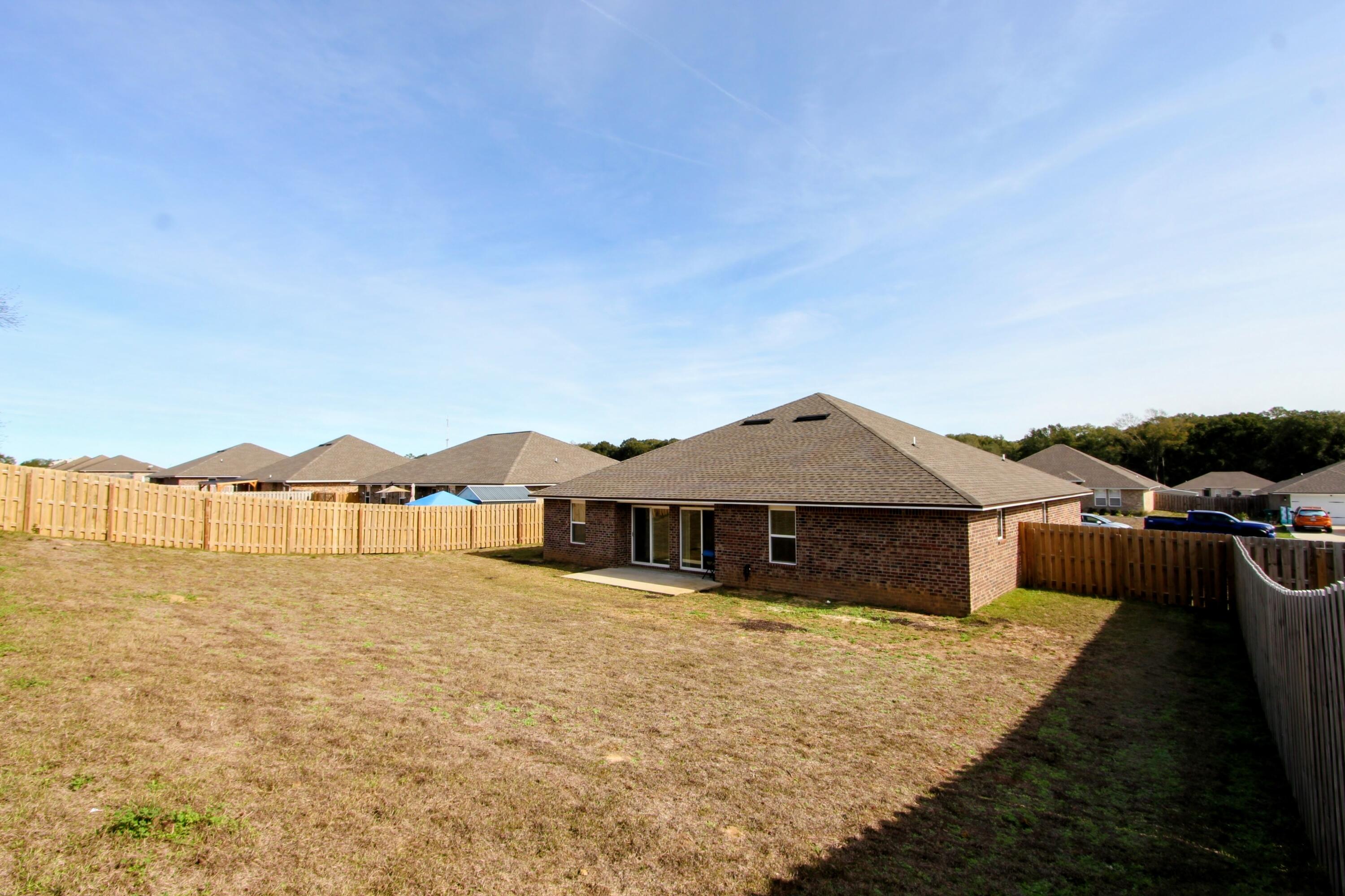 5438 Lee Farm Boulevard Crestview, FL 32536 - Photo 49 of 50 a front view of a house with yard and seating