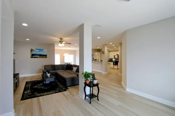 a living room with furniture and a wooden floor