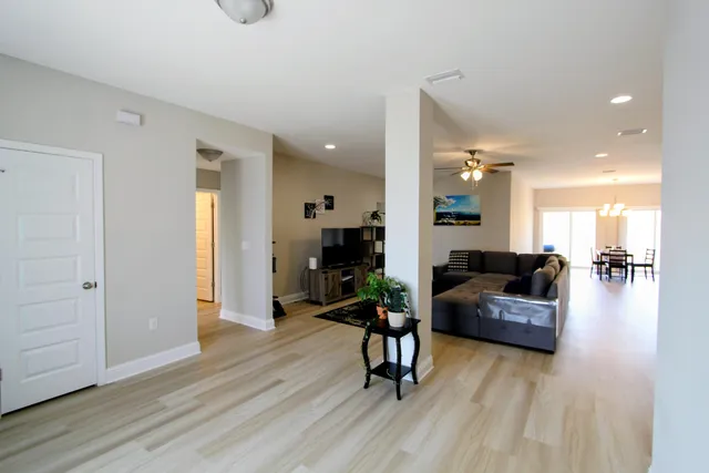 a living room with furniture and a wooden floor