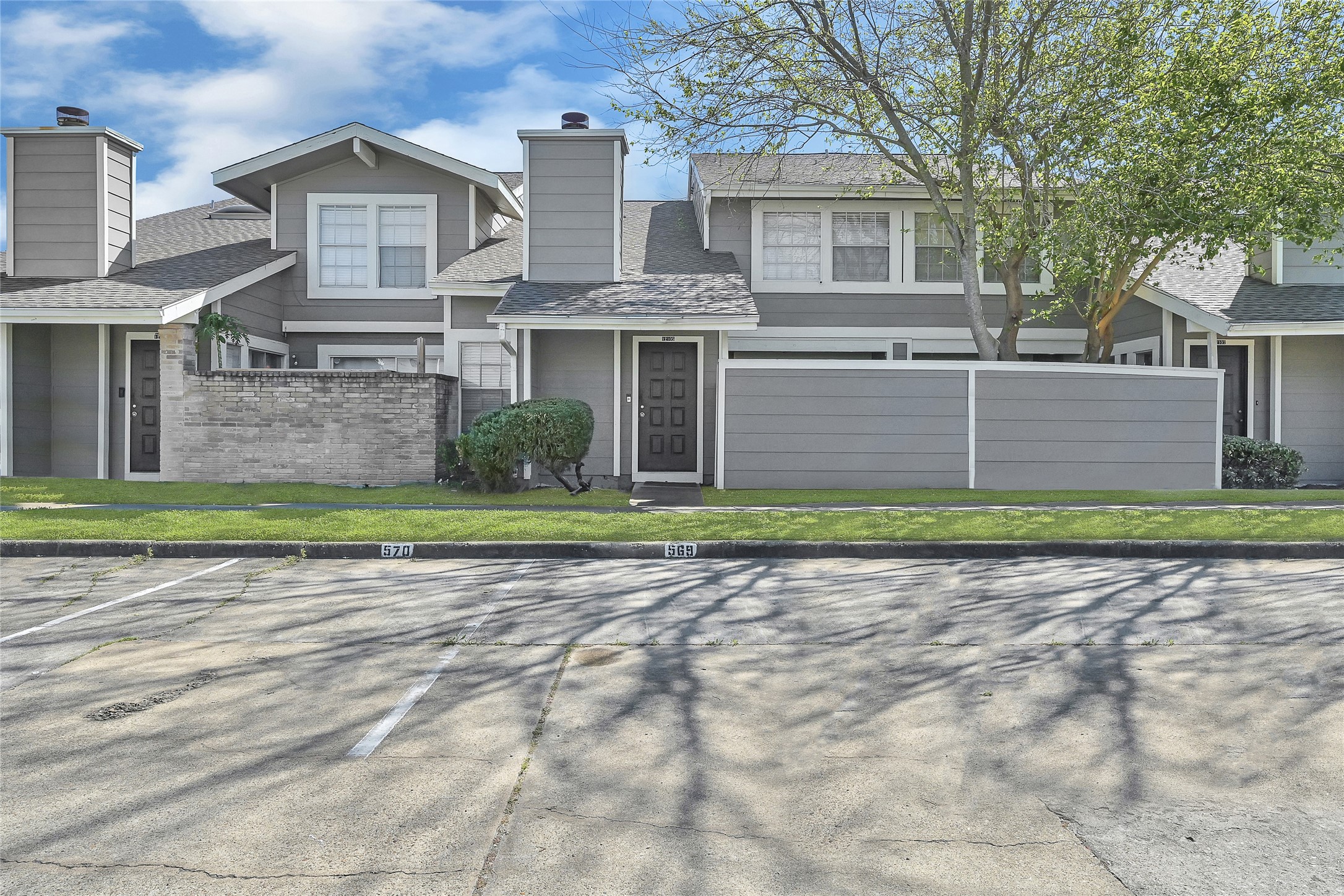12111 Lemon Ridge Lane, Unit 121 Houston, TX 77035 - Photo 21 of 25 a front view of a house with a yard and garage