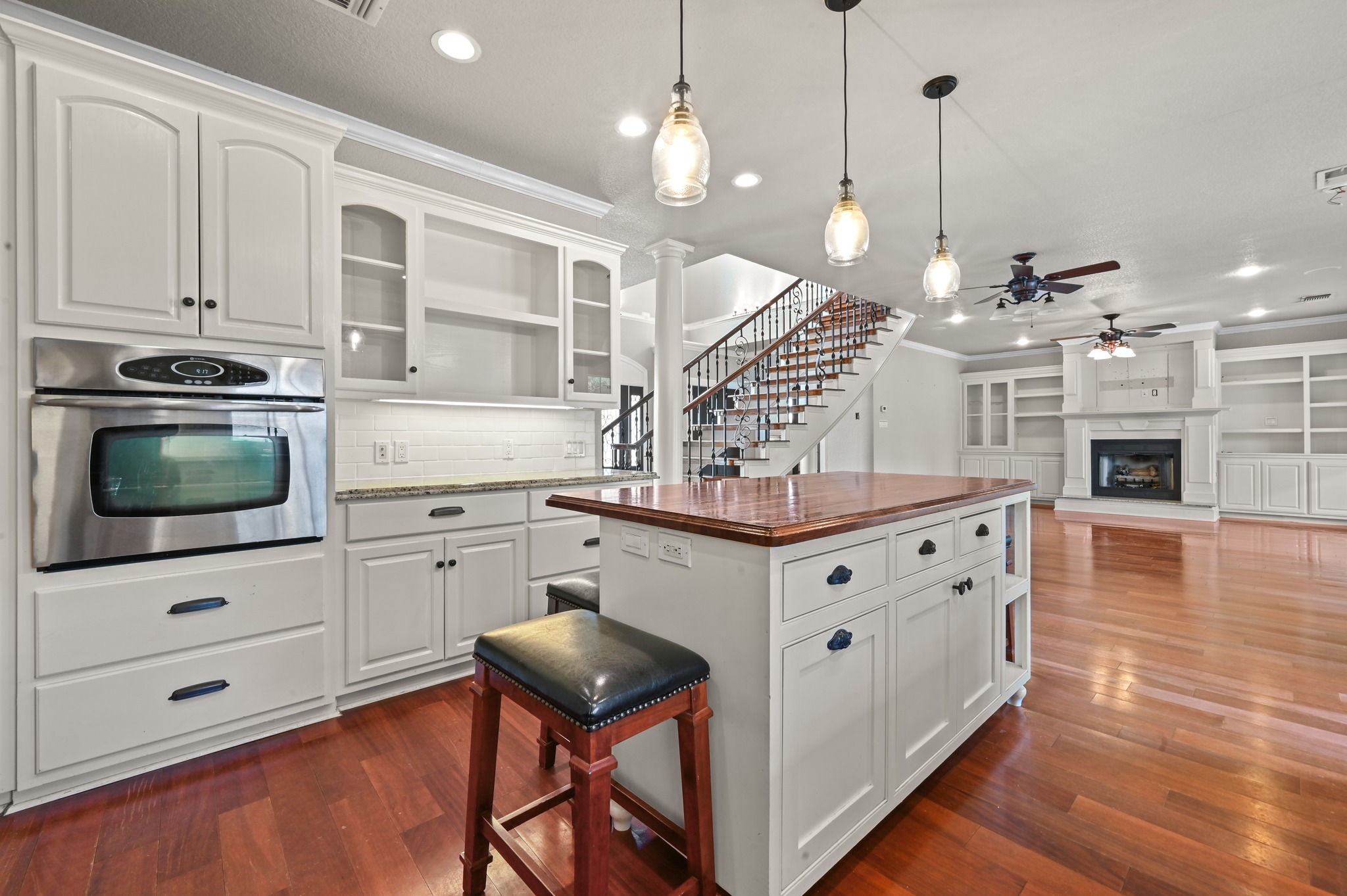 1175 Southern Way Luling, TX 78648 - Photo 22 of 40 A well-appointed kitchen island anchors this open concept living space with gleaming hardwood flooring throughout.