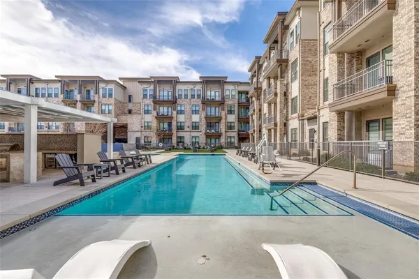 a view of a patio with a table and chairs and potted plants