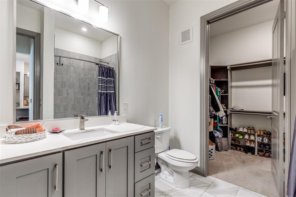2700 Old Denton Road, Unit 2203 Carrollton, TX 75007 - Photo 12 of 13 a bathroom with a sink a toilet and shower