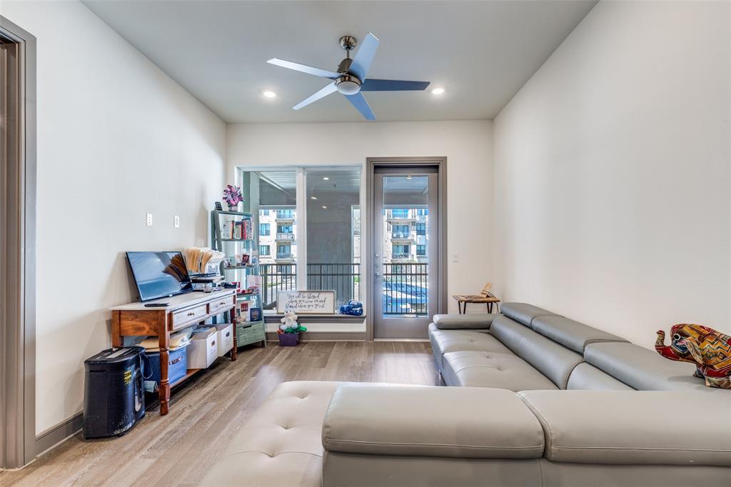 2700 Old Denton Road, Unit 2203 Carrollton, TX 75007 - Photo 3 of 13 a living room with furniture and a chandelier