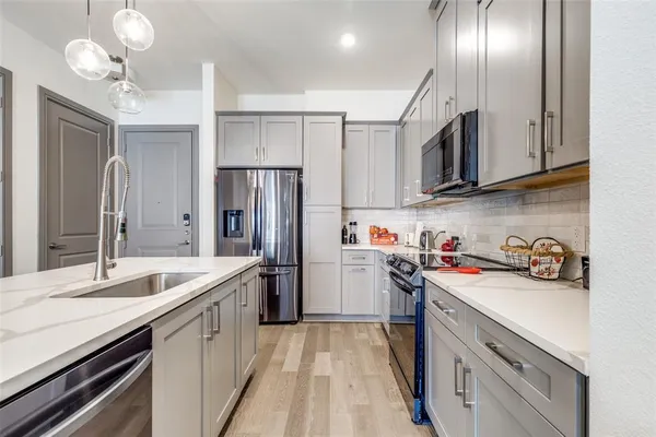 a kitchen with a sink cabinets and stainless steel appliances