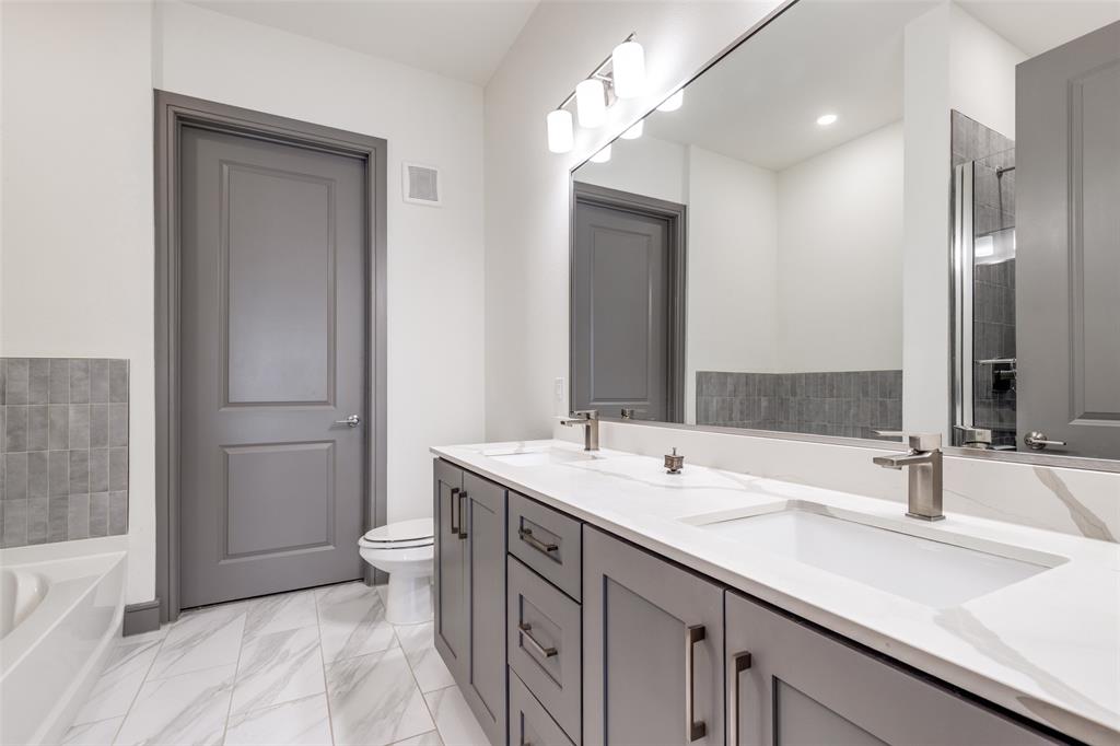 2700 Old Denton Road, Unit 2203 Carrollton, TX 75007 - Photo 9 of 13 a bathroom with a sink a toilet and shower