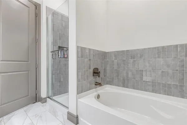 a bathroom with a bathtub and shower