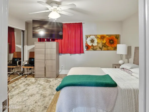 a bedroom with a bed and a flat screen tv