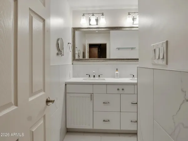 a bathroom with a sink vanity and mirror