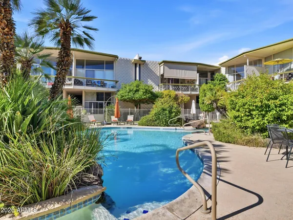 a swimming pool with outdoor seating and yard