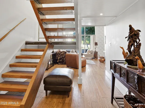 a living room with furniture and a wooden floor