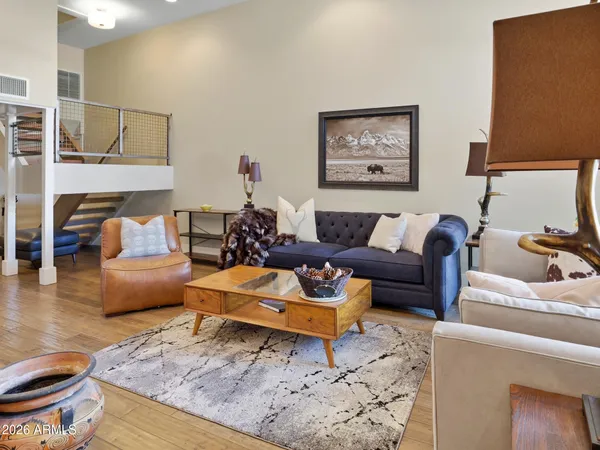a living room with furniture and wooden floor