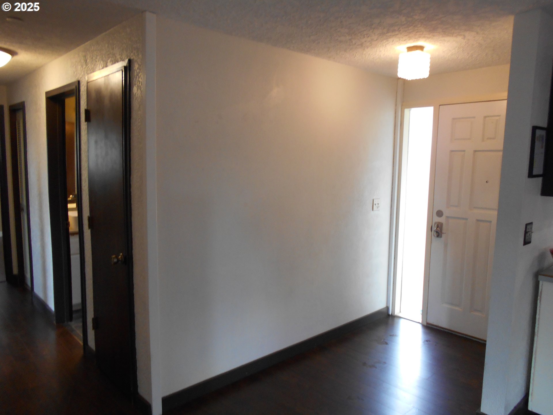 4565 Souza Street Eugene, OR 97402 - Photo 14 of 43 an empty room with wooden floor and a bathroom