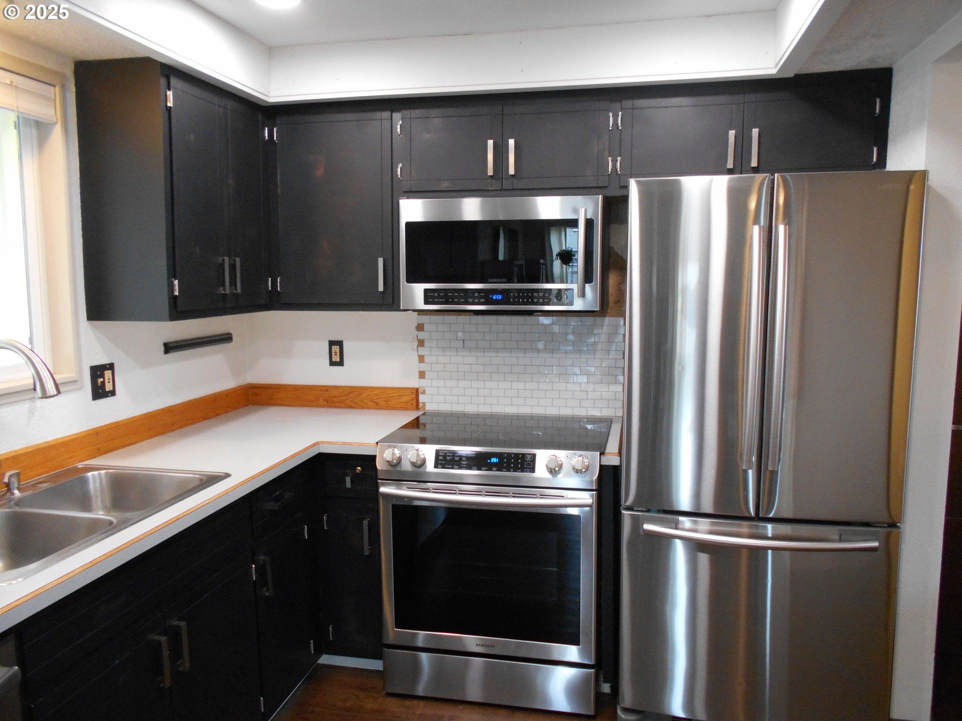 4565 Souza Street Eugene, OR 97402 - Photo 16 of 43 a kitchen with a refrigerator and a sink