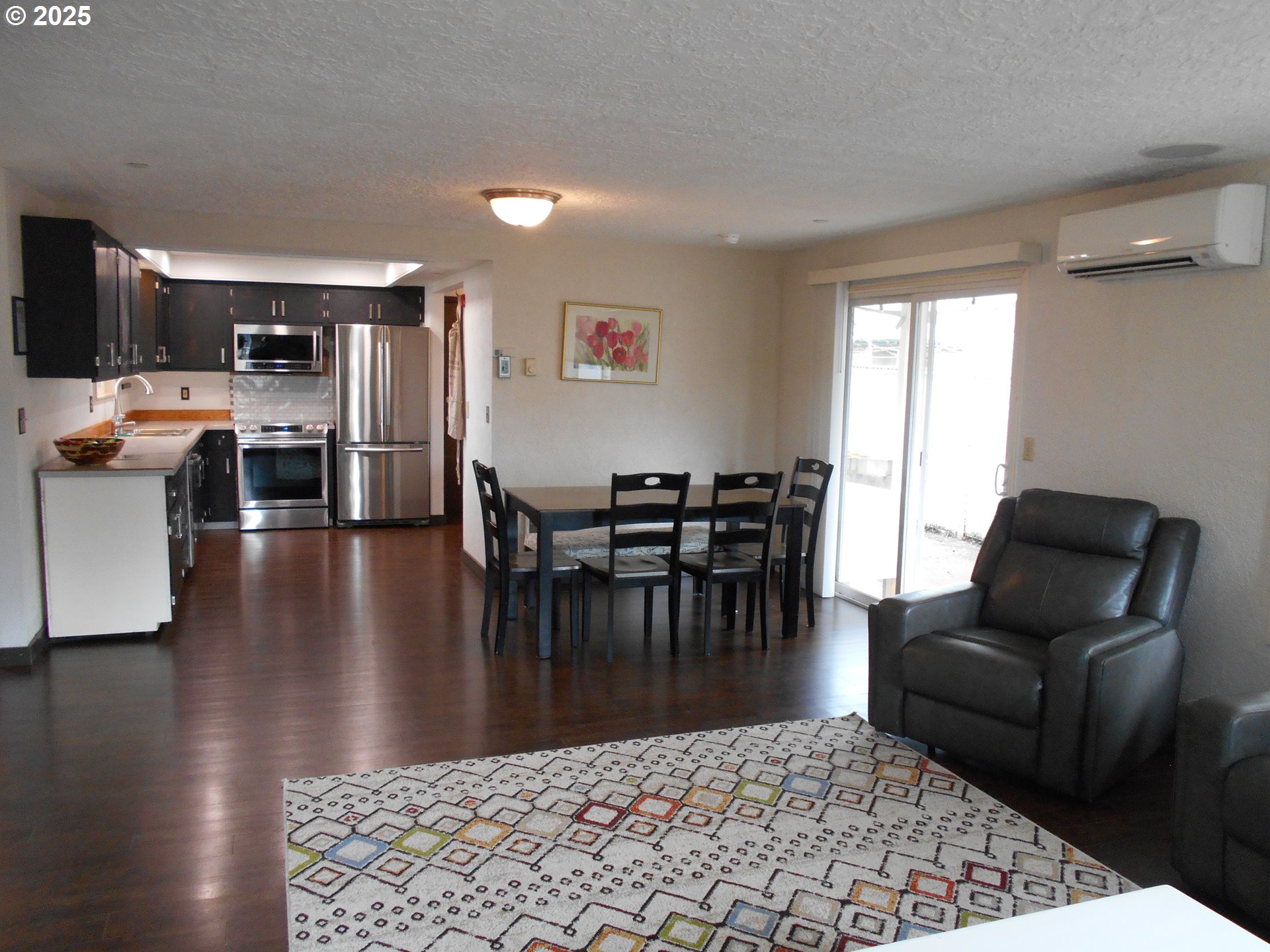 4565 Souza Street Eugene, OR 97402 - Photo 18 of 43 a living room with furniture wooden floor and a table