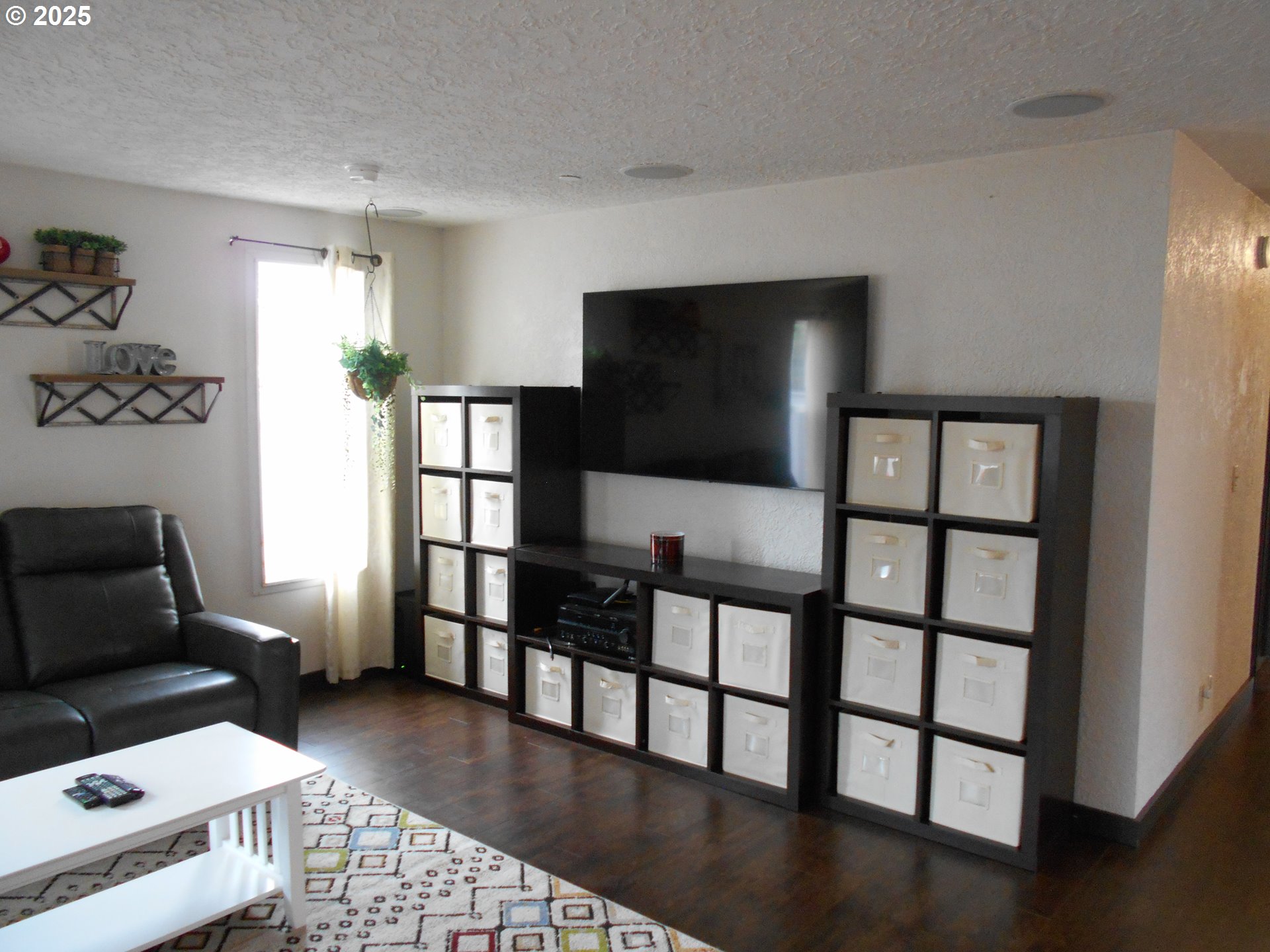 4565 Souza Street Eugene, OR 97402 - Photo 20 of 43 a living room with furniture and a flat screen tv