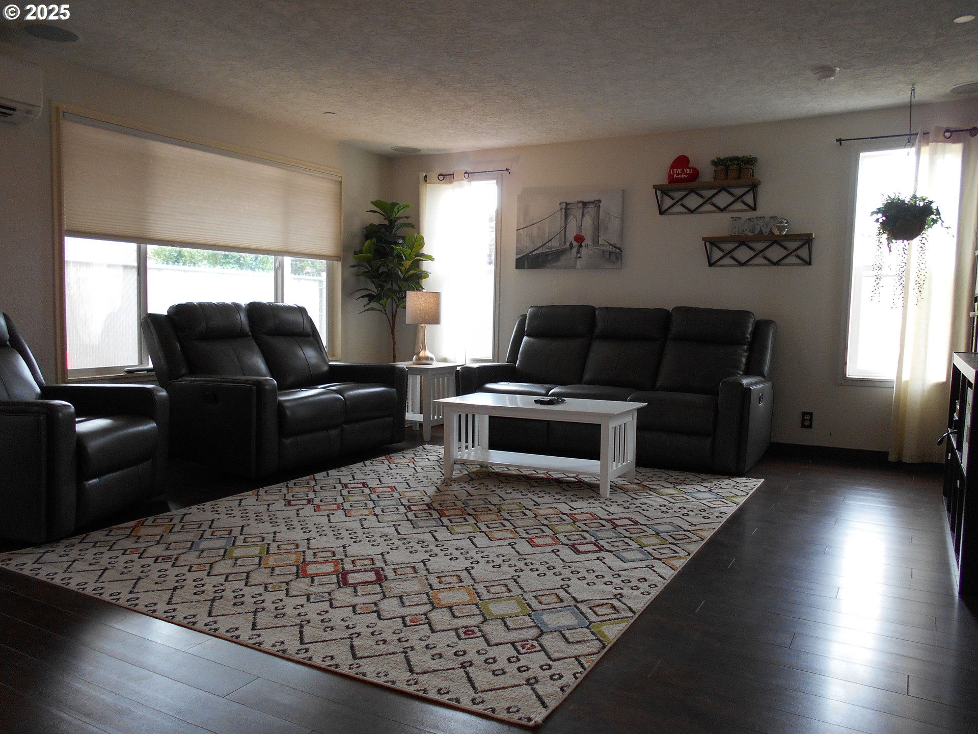 4565 Souza Street Eugene, OR 97402 - Photo 22 of 43 a living room with furniture windows and a fireplace