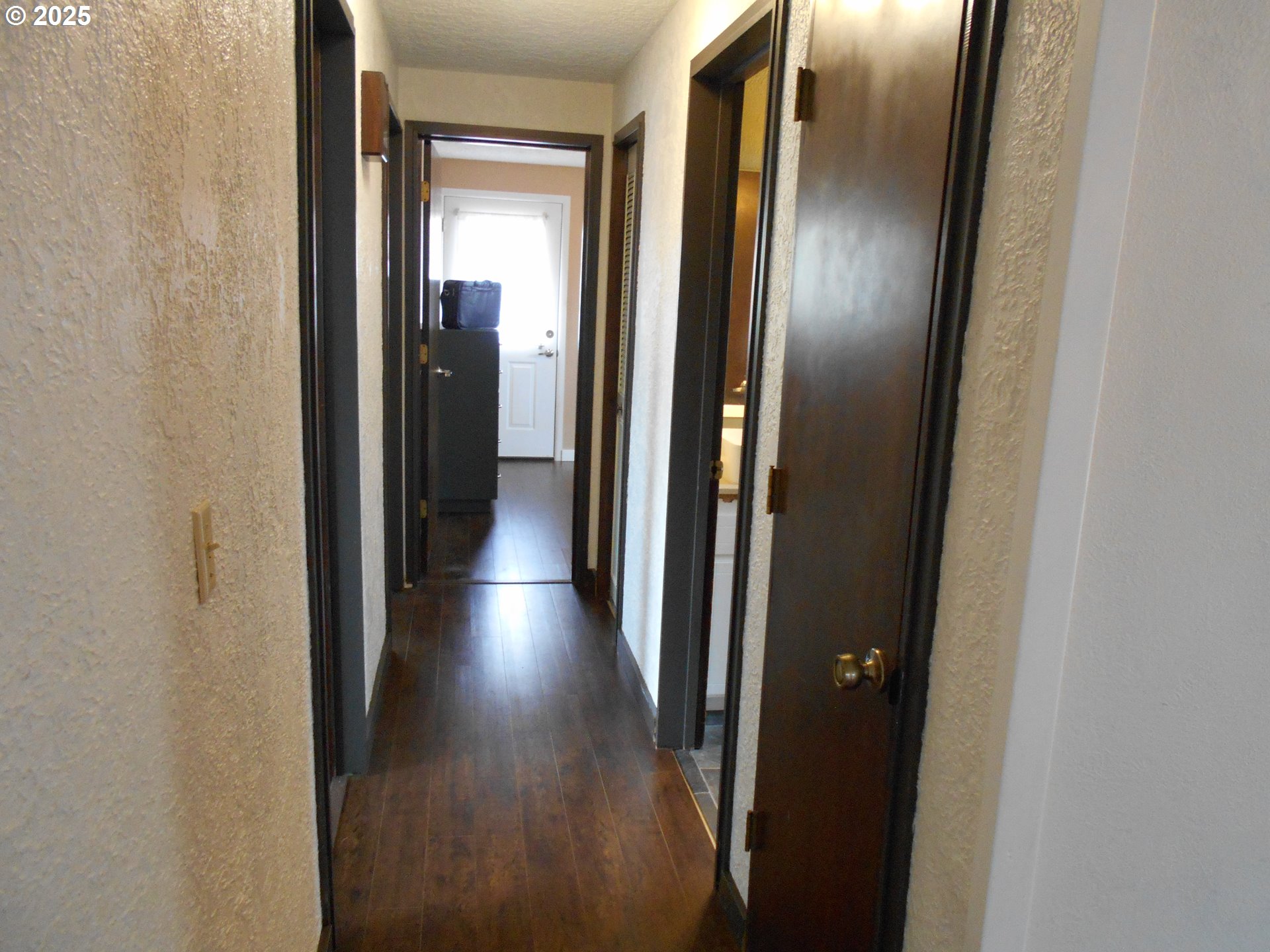 4565 Souza Street Eugene, OR 97402 - Photo 24 of 43 a view of a hallway with wooden floor