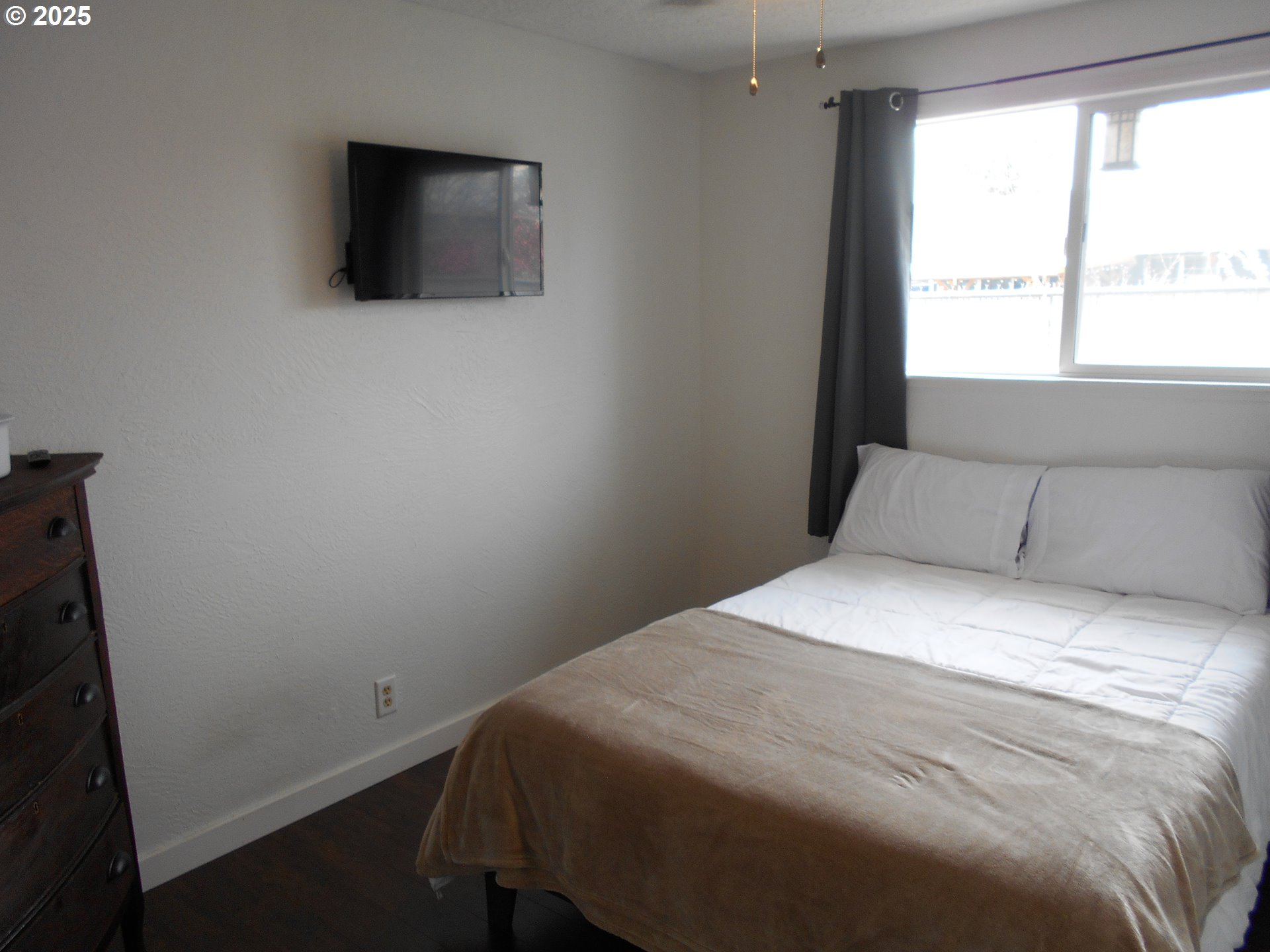 4565 Souza Street Eugene, OR 97402 - Photo 25 of 43 a bedroom with a bed and a flat screen tv