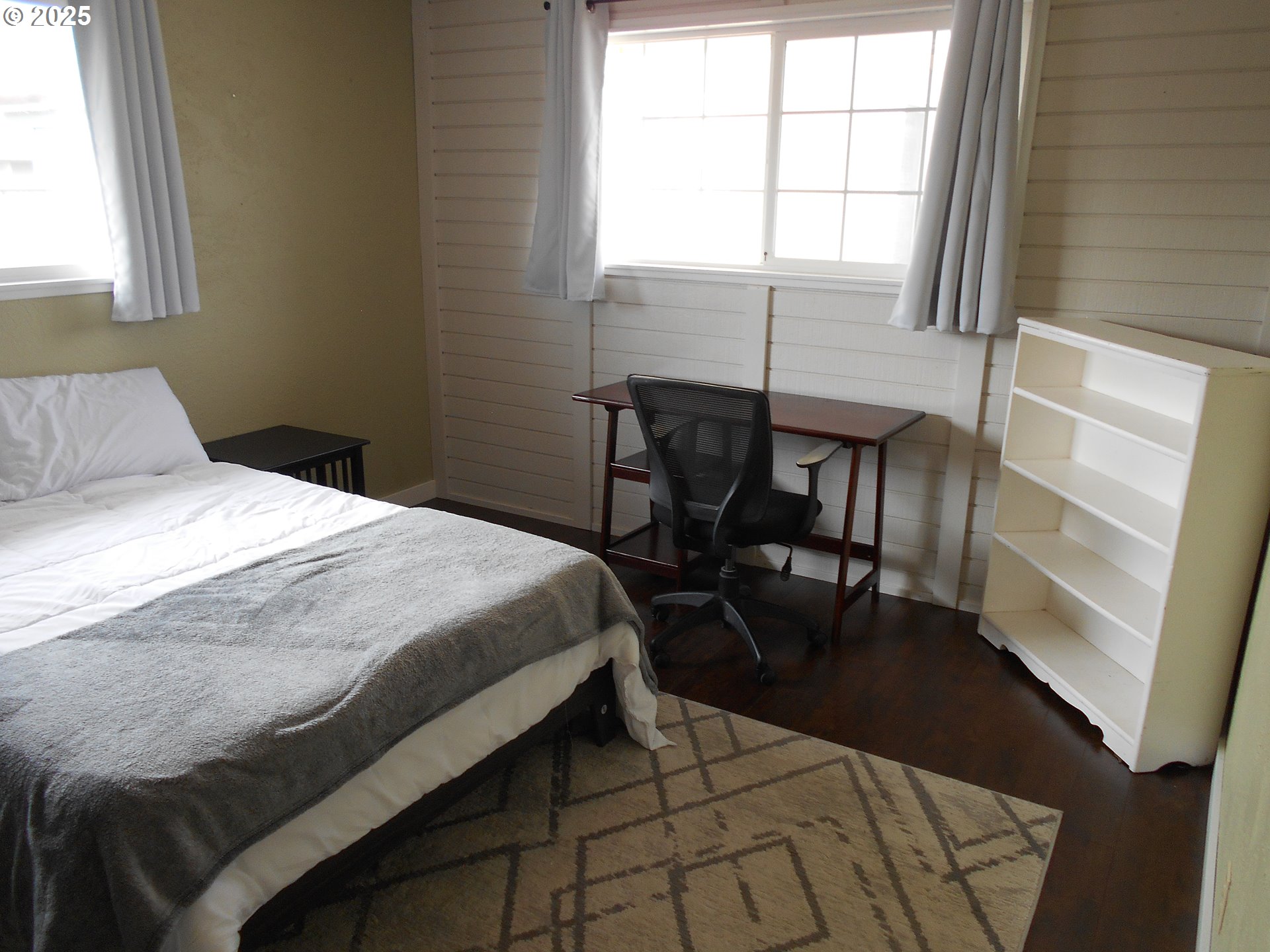4565 Souza Street Eugene, OR 97402 - Photo 30 of 43 a bedroom with a bed a table and windows